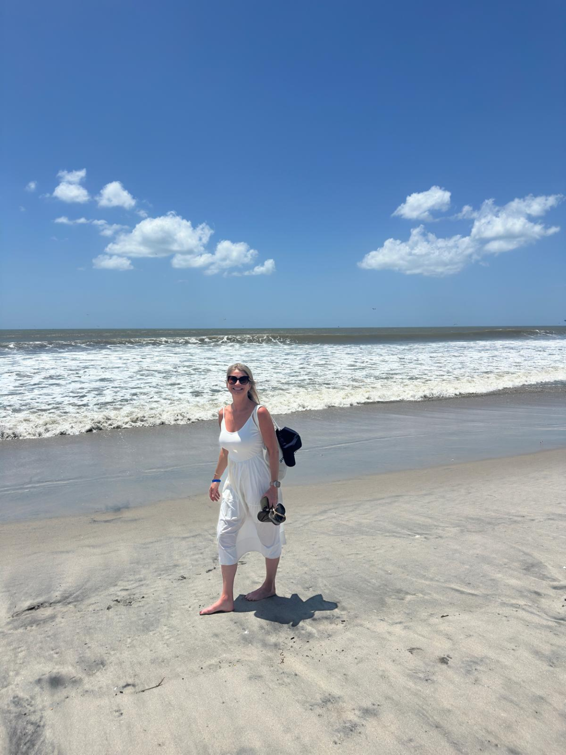 Jen, co-founder of Location Free Living, standing on a beach