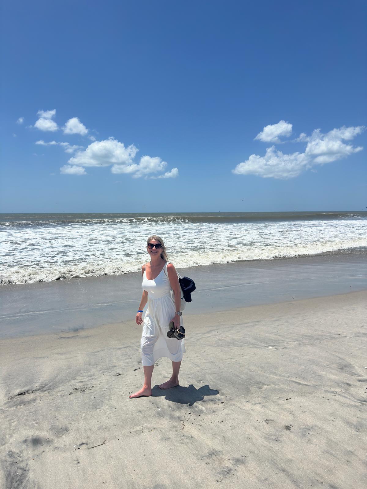 Jen, co-founder of Location Free Living, standing on a beach